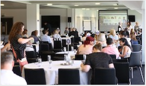 Conference attendees sitting at a table.